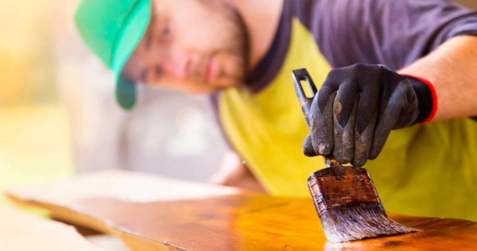 Worker varnishing a board who know how to Find Handyman Work in Order to Grow Your Business