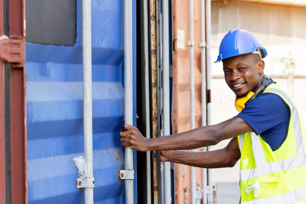 Worker opening a container with confidence because he can count on contractor liability insurance.