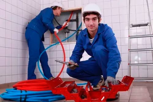 Plumbers at work who know easy ways for a plumbing contractor to keep his team motivated