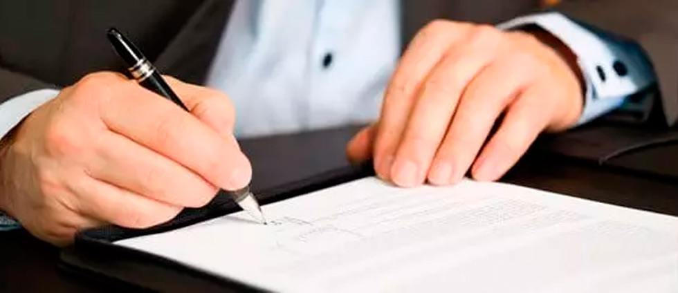 Man signing a document of a Certificate of Liability Insurance Overview