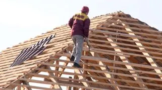 Man climbing on a roof because it knows how To Protect Your Contractor Business Against Liability Claims