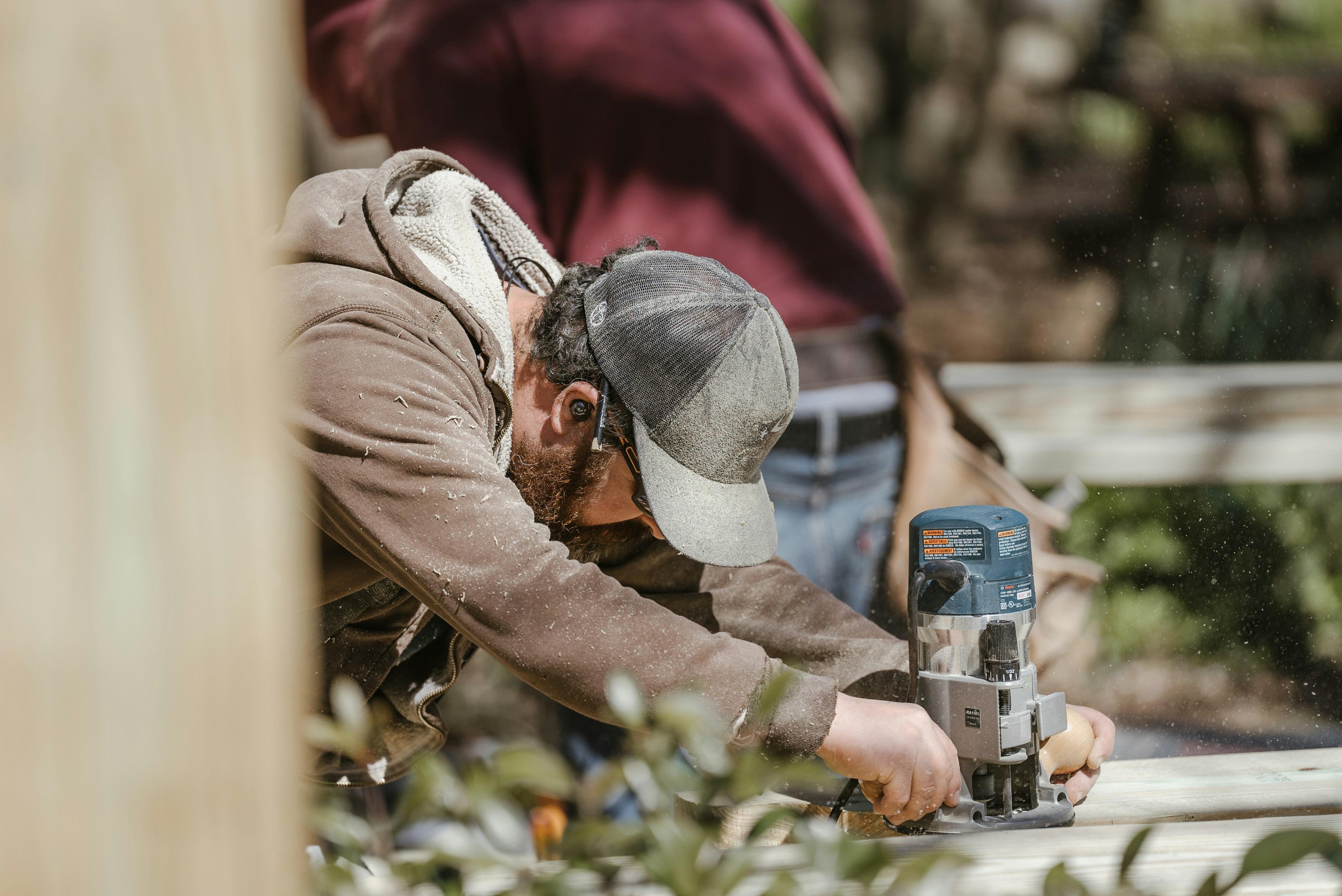 Contractor using a power tool on a job site representing the need for contractors insurance quotes